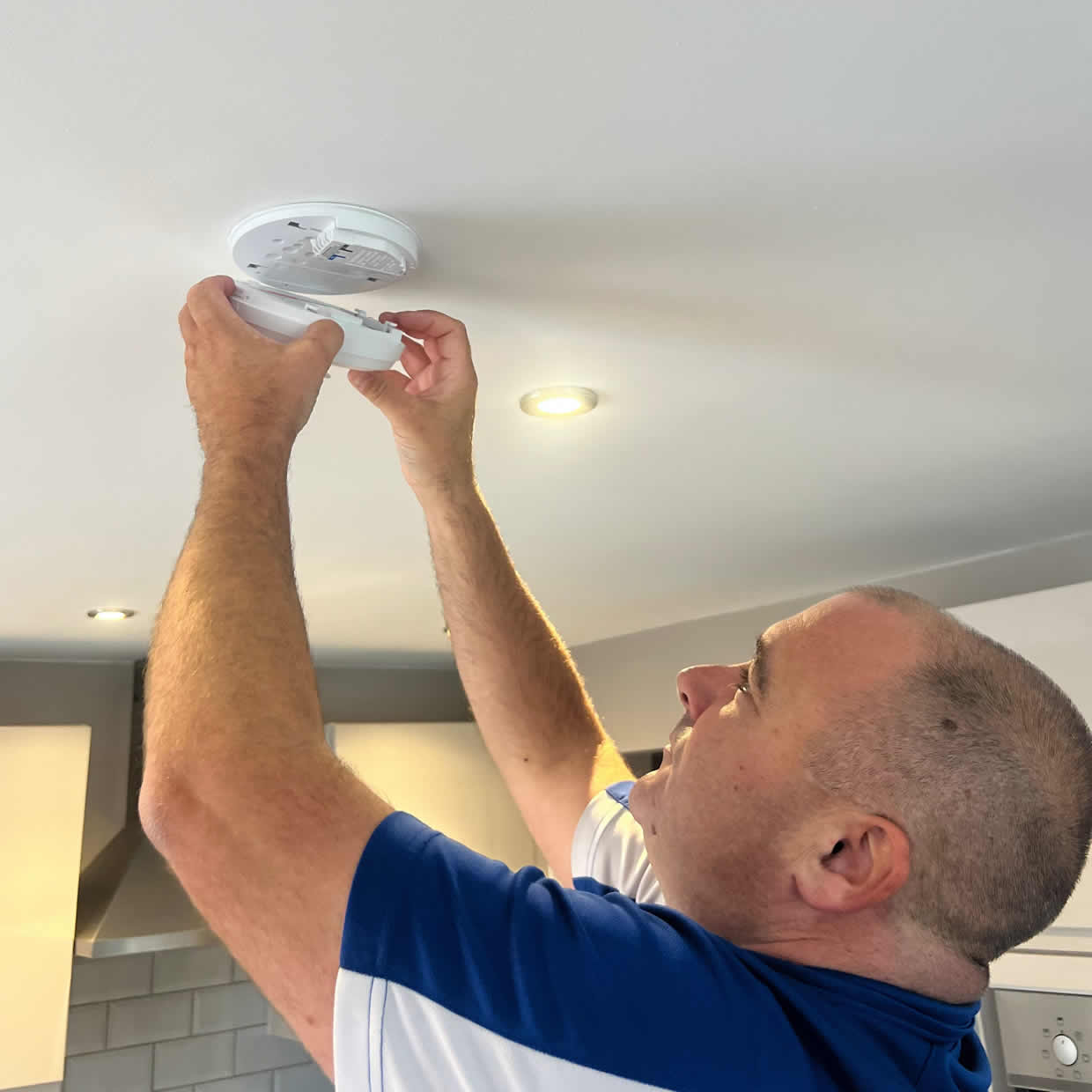 Smoke alarm being installed on a ceiling in Stirling